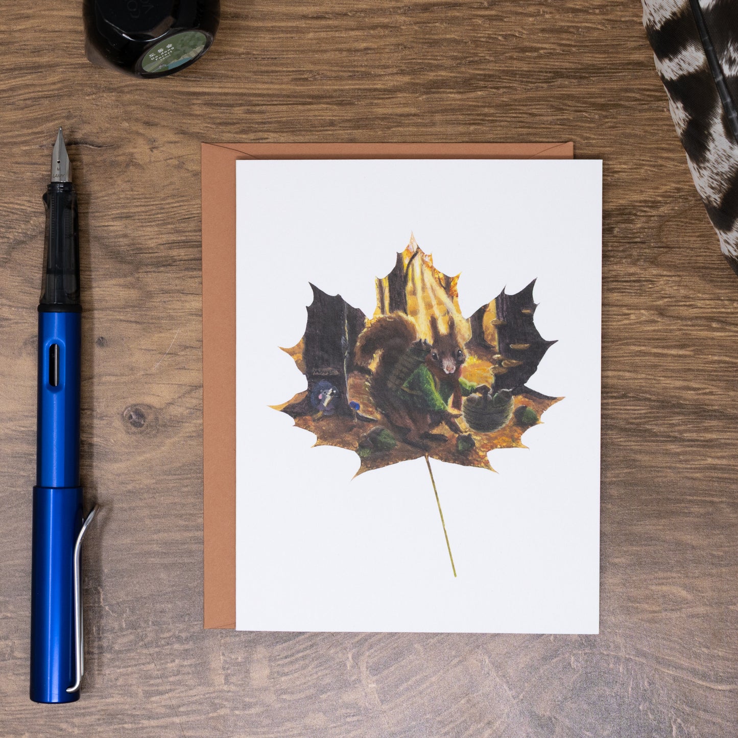 folded greeting card with squirrel artwork and a terracotta envelope