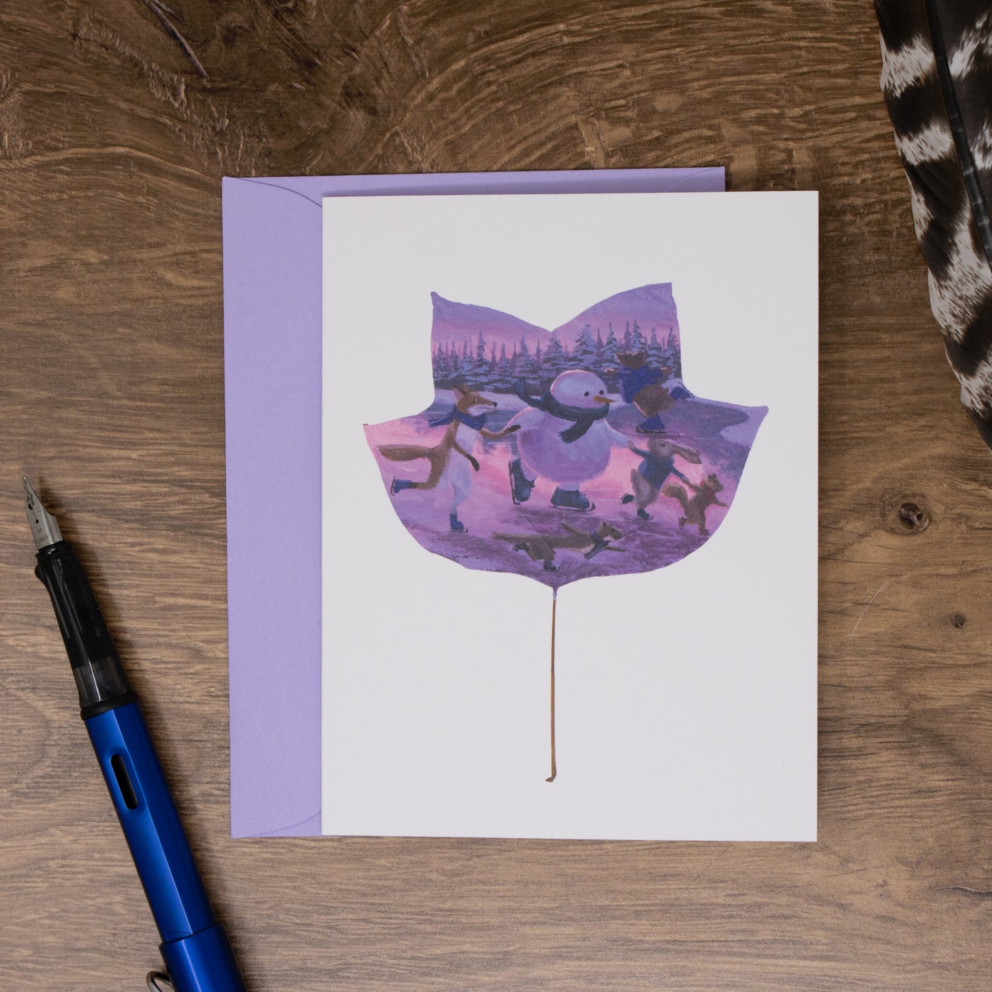 Greeting card on a wooden surface with a pen.
