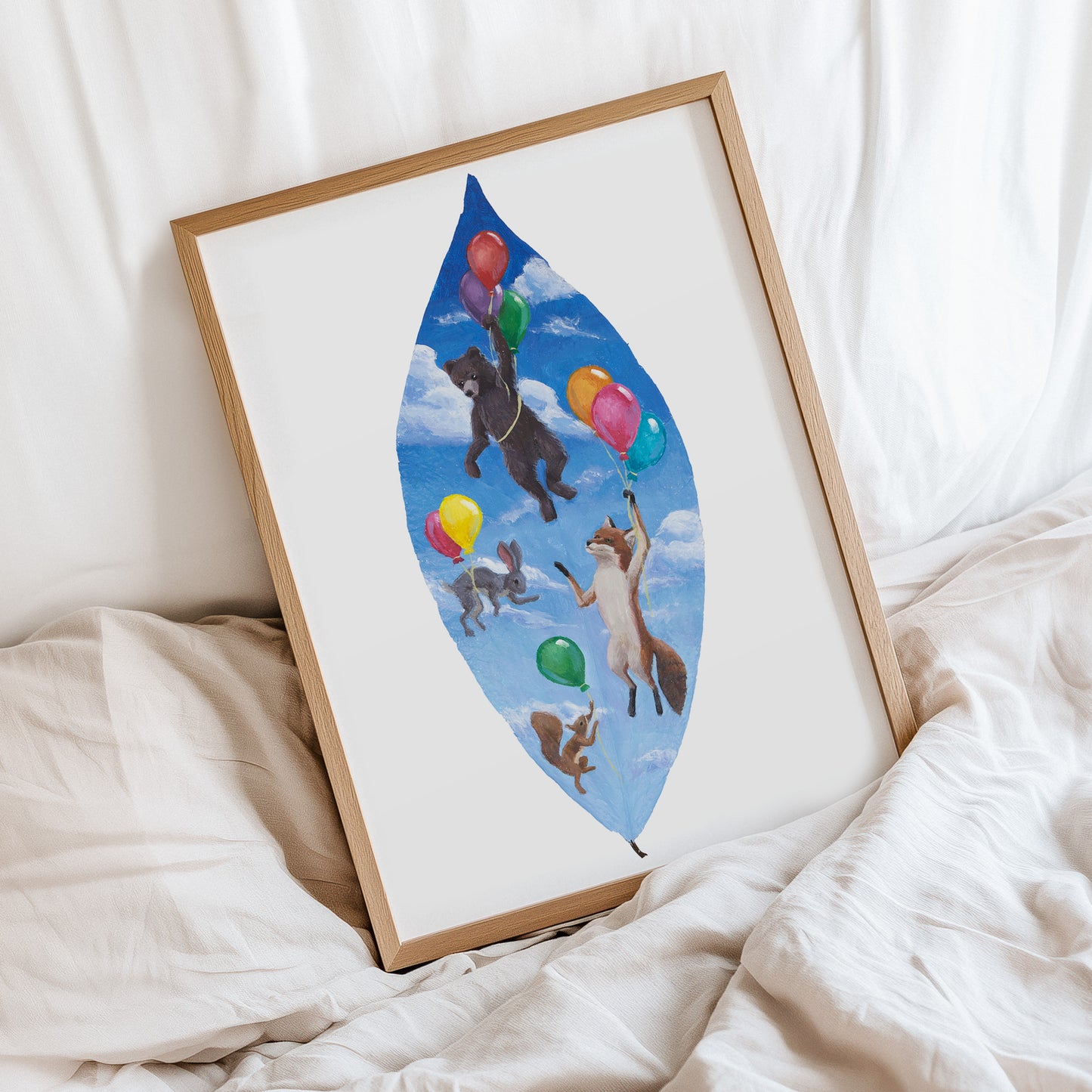 Framed artwork of animals with balloons on a white surface