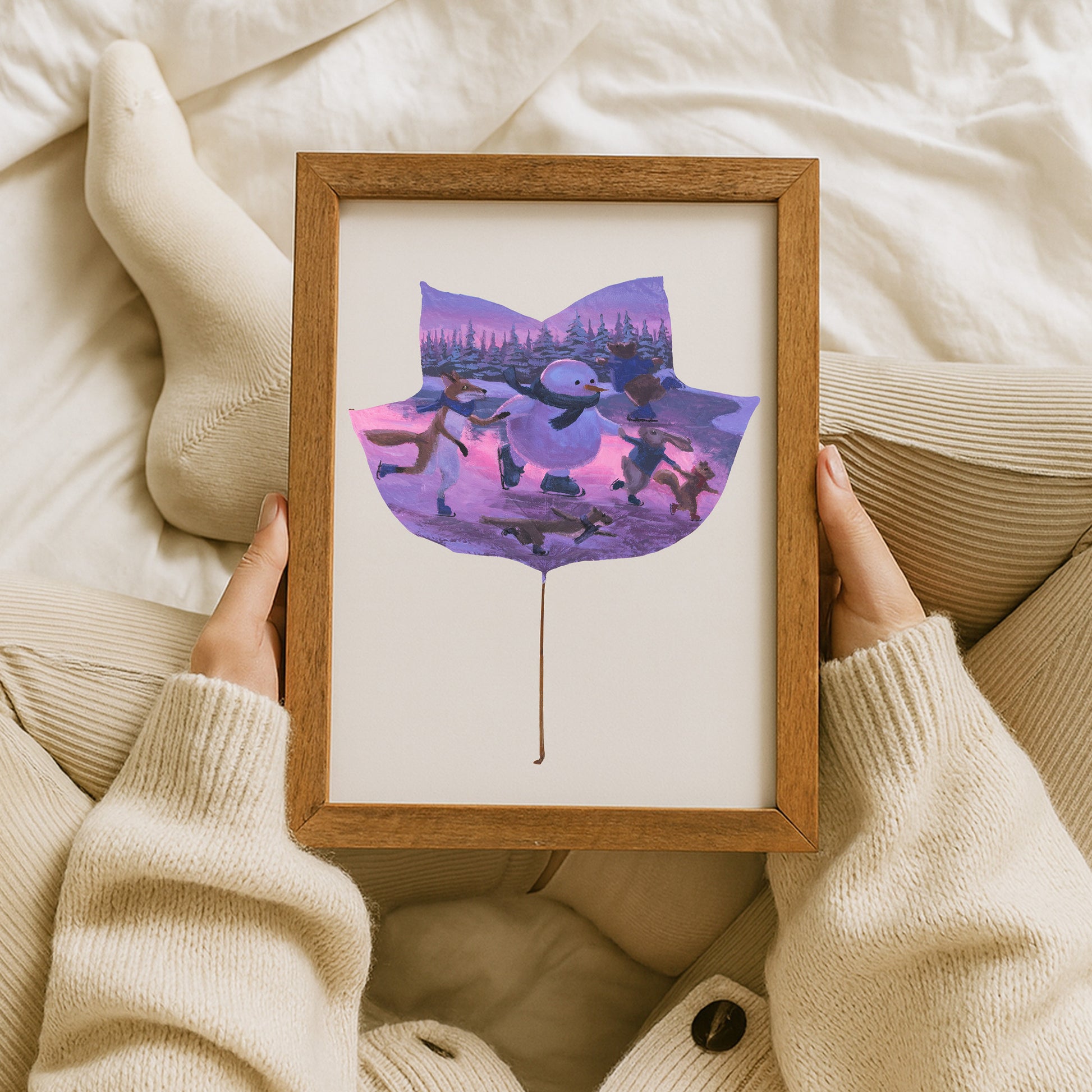 framed artwork of a leaf painting with a snowman and woodland animals.