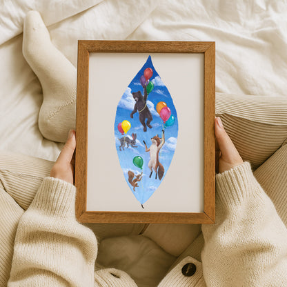 Framed artwork of animals with balloons held by a person wearing a beige sweater.