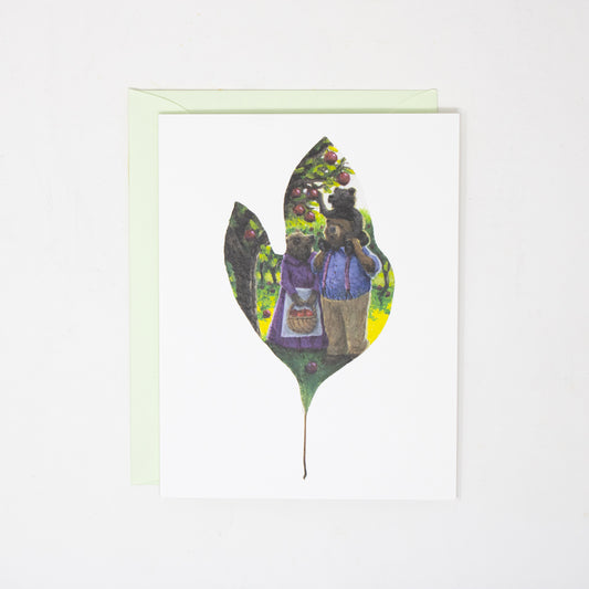 folded greeting card with bear family artwork and a light green envelope.
