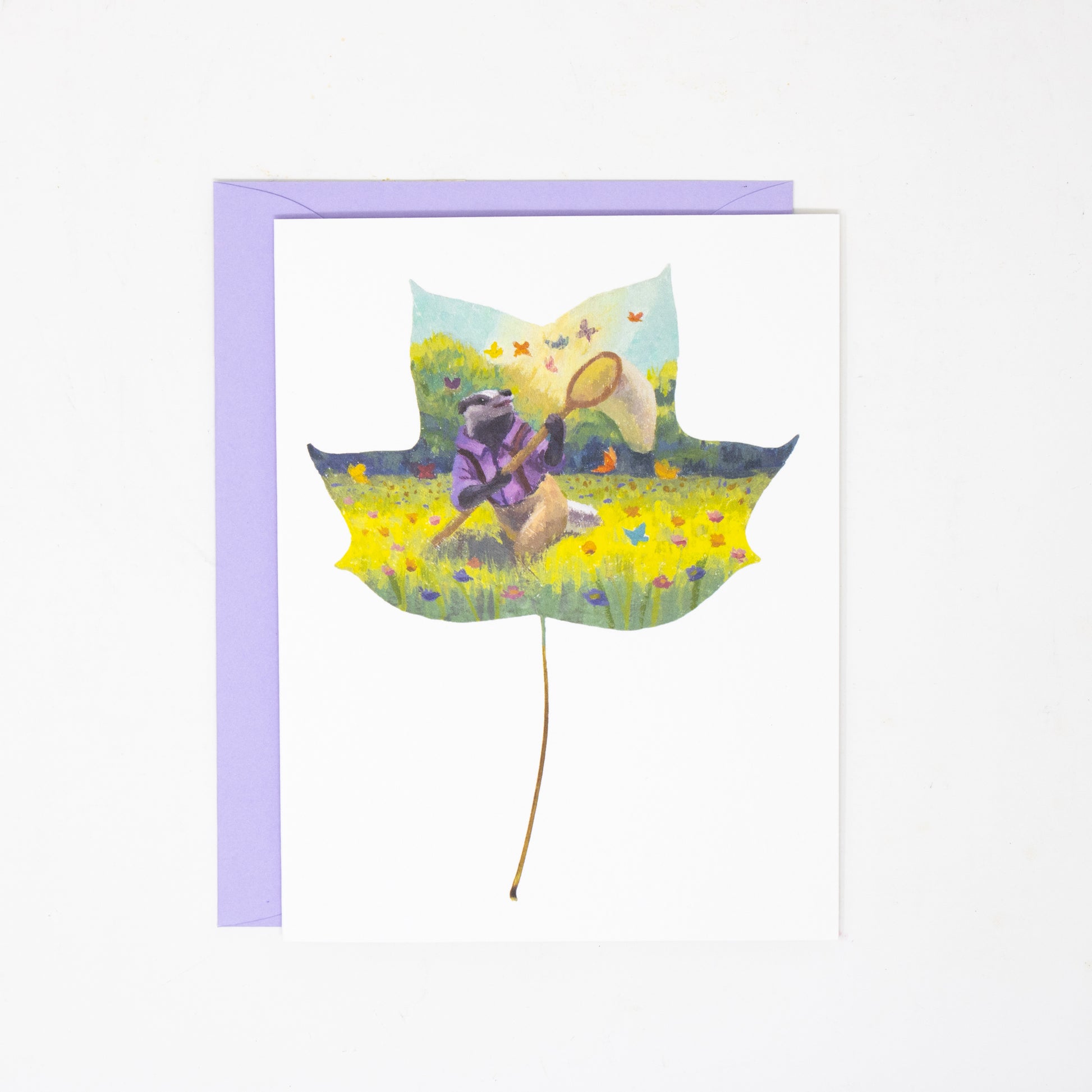 greeting card with a leaf design with a badger and butterflies