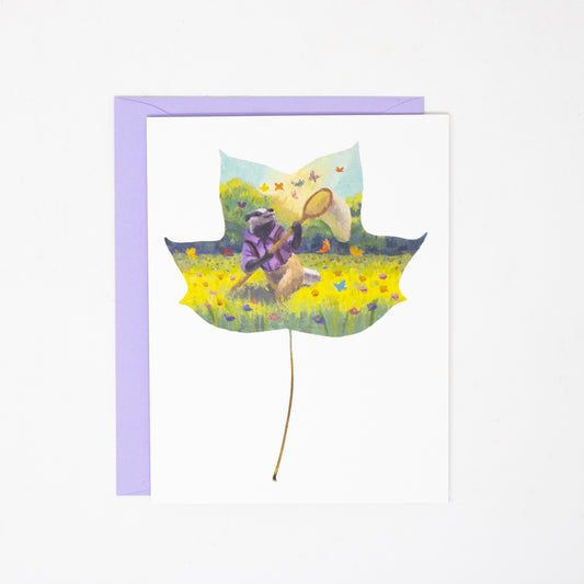 greeting card with a leaf design with a badger and butterflies