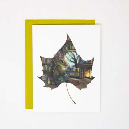 Greeting card with a leaf design featuring a chipmunk and books on a white background