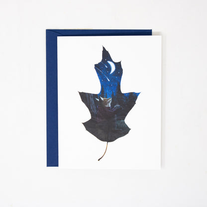 folded greeting card with dark blue envelope on a white background