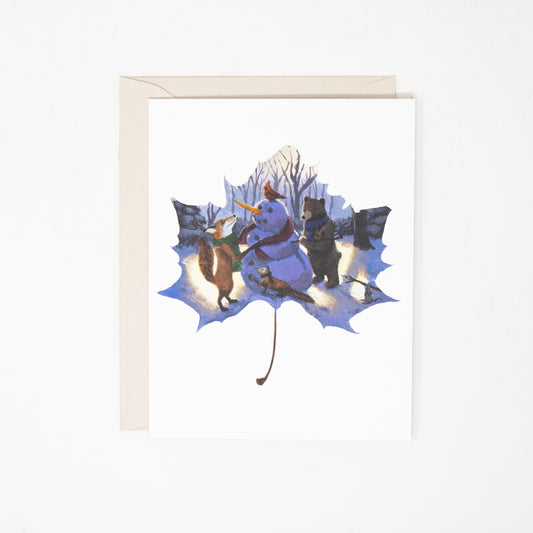 Framed artwork of a leaf with winter-themed illustration of animals on a white background