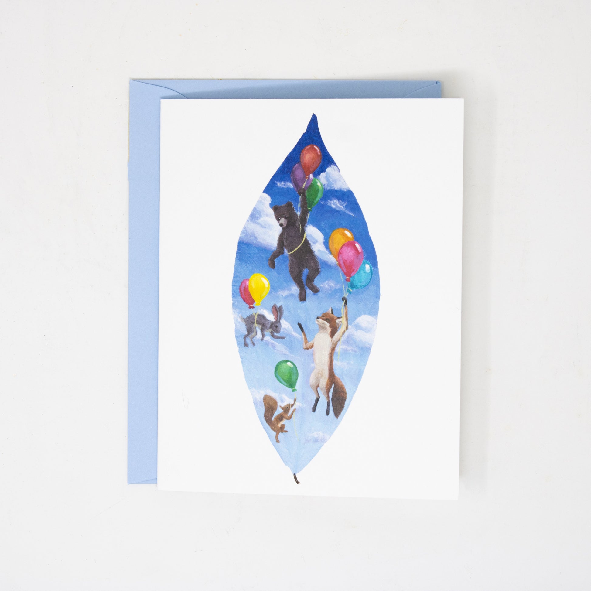 Greeting card with woodland animals and balloons on a blue background