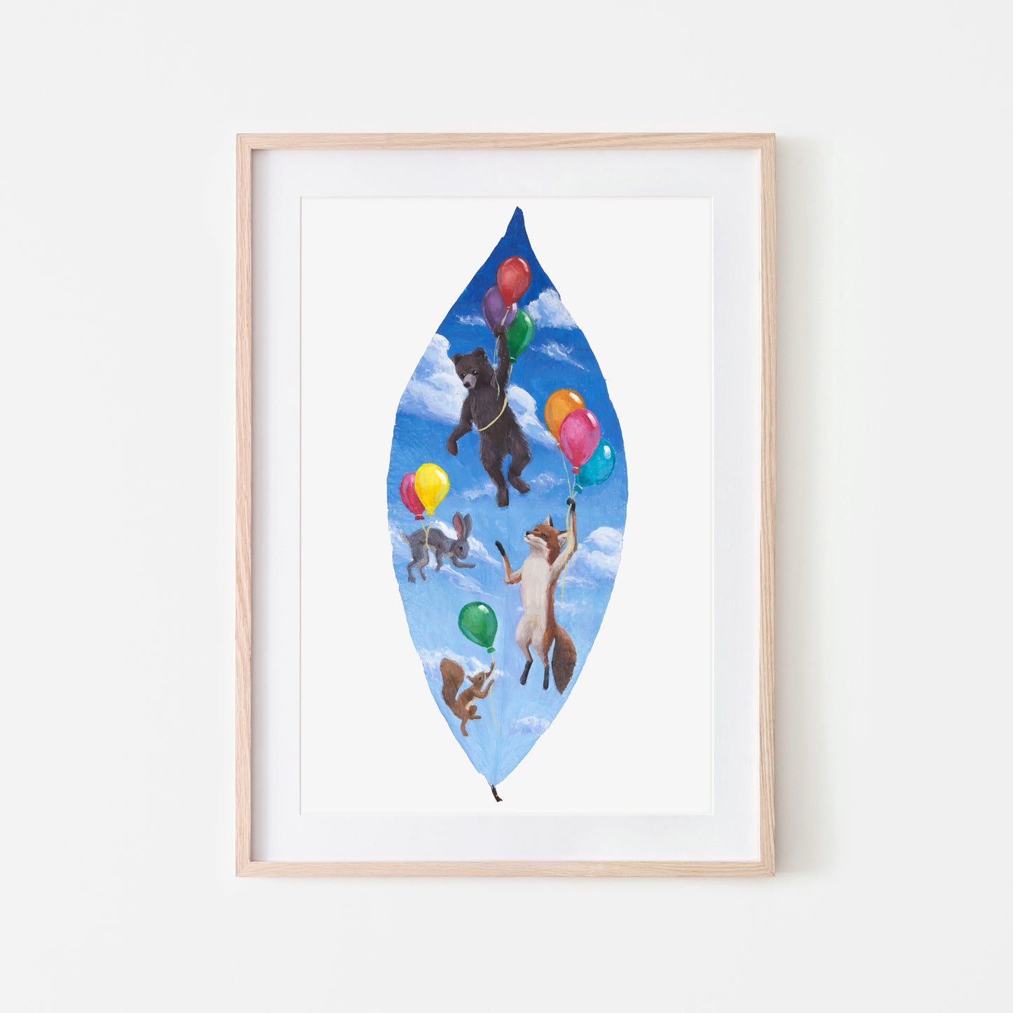 Framed artwork of animals with balloons on a blue leaf-shaped background