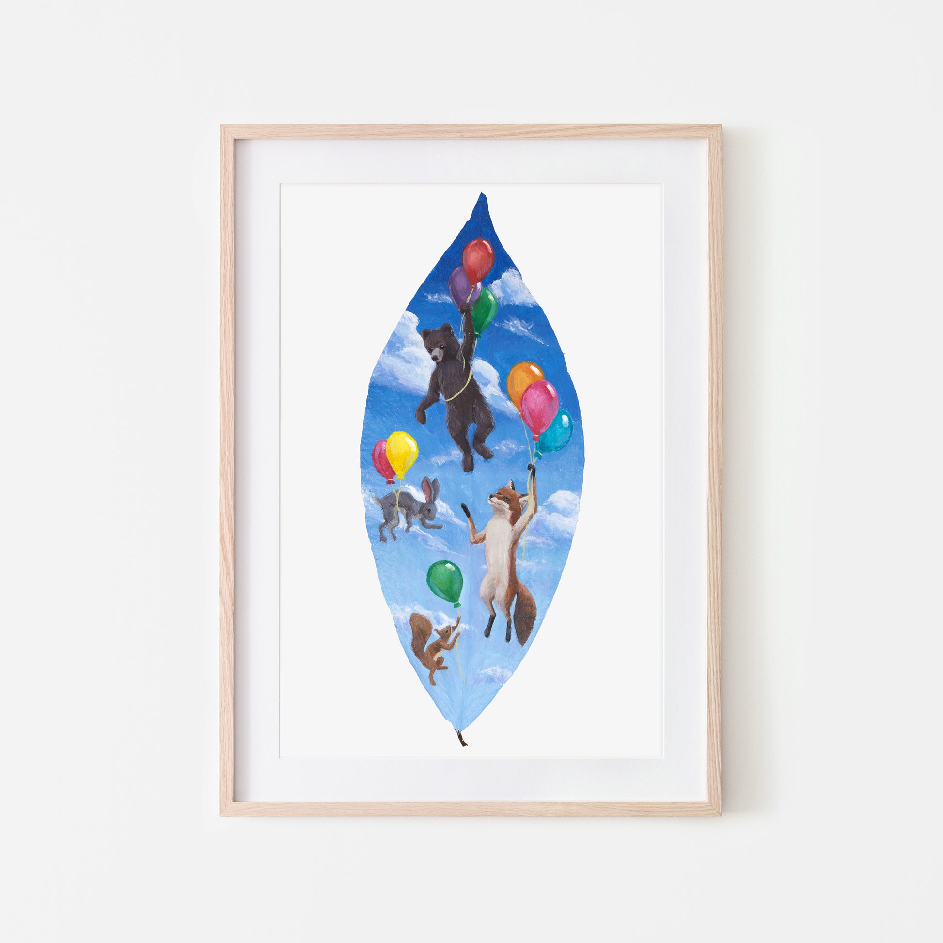 Framed artwork of animals with balloons on a blue leaf-shaped background