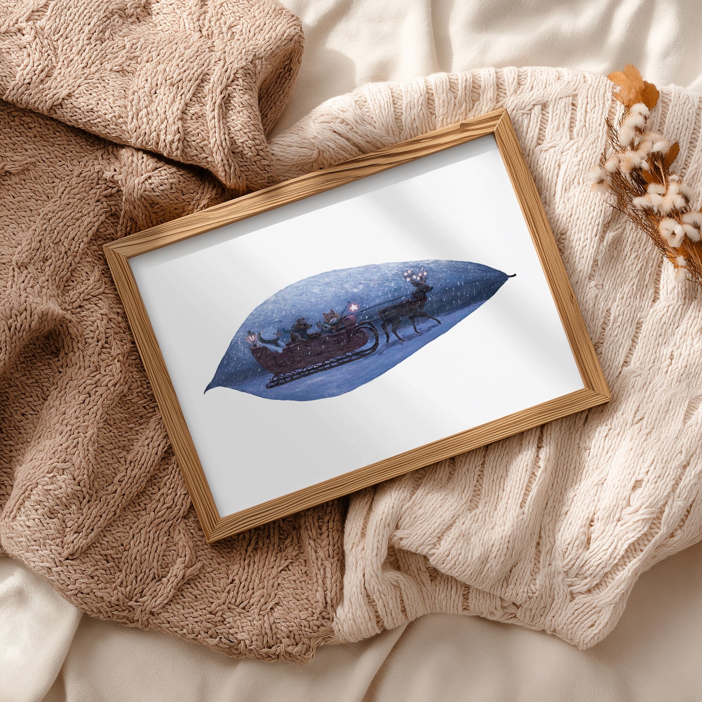 Framed artwork of a blue leaf in a cozy setting